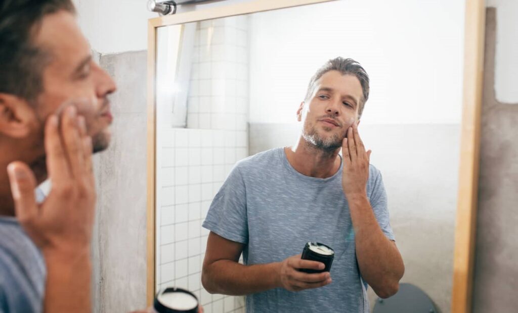 Homem passa creme na barba